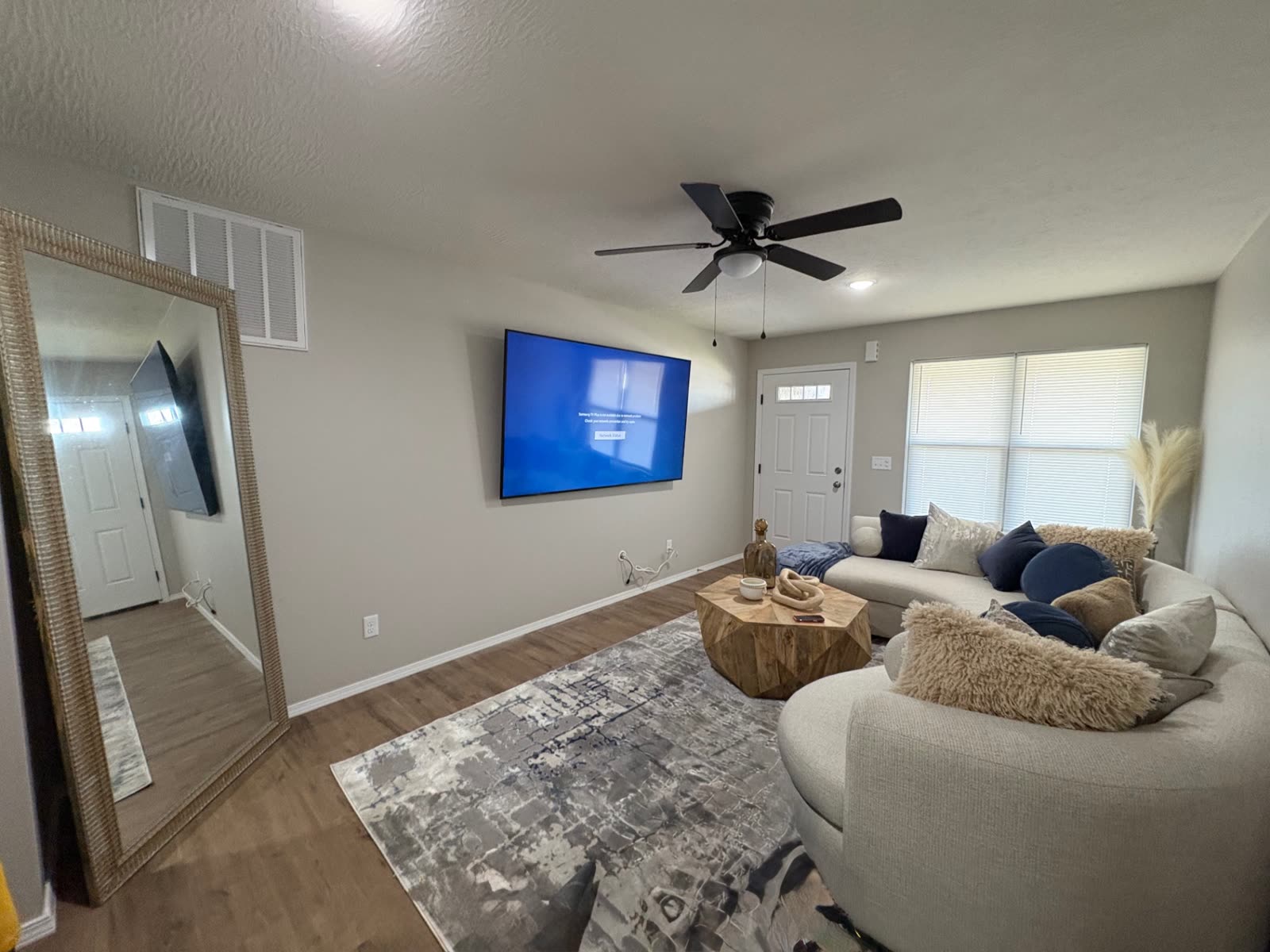 TV mounted in a bright open-concept living room